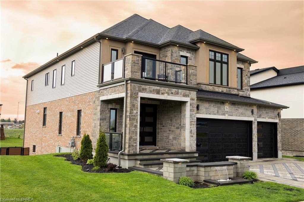 Contemporary stone and siding exterior with a dark shingled roof
