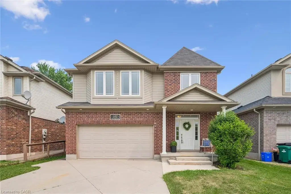 Two-story brick and siding residence featuring an attached 2 car garage and a covered front porch.