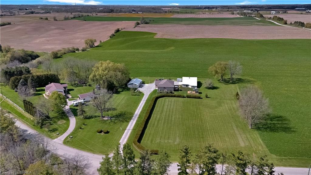 Expansive property featuring a private driveway, manicured lawns, and mature trees