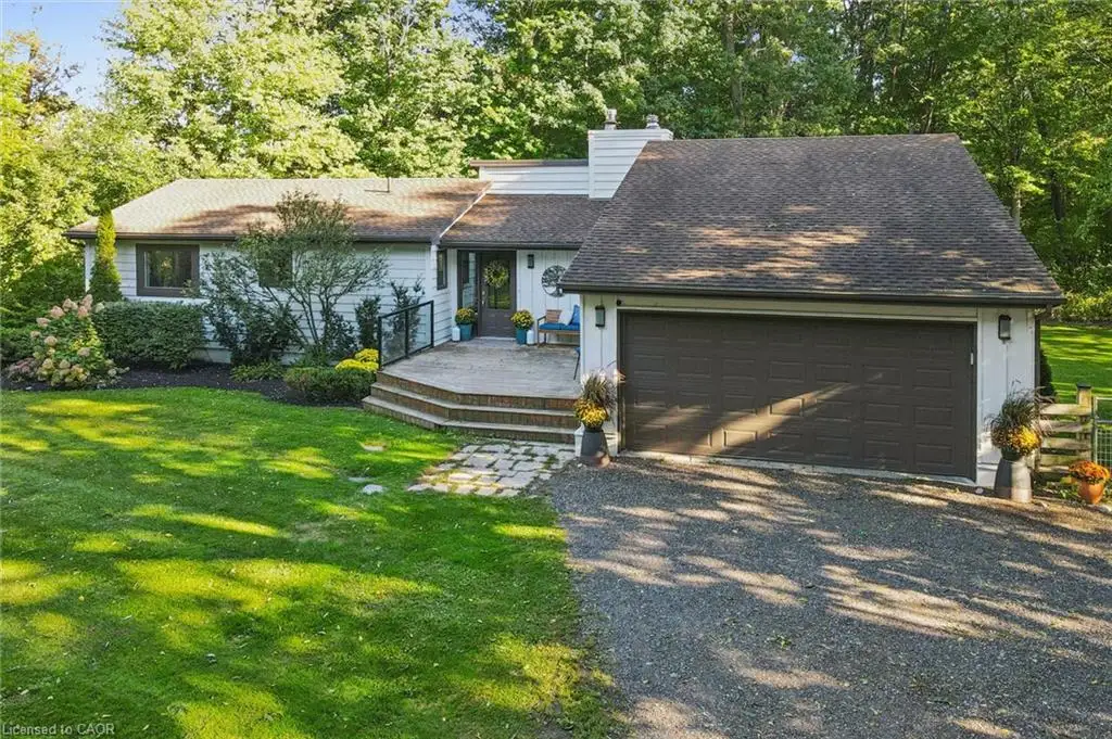 White exterior with a dark asphalt shingle roof