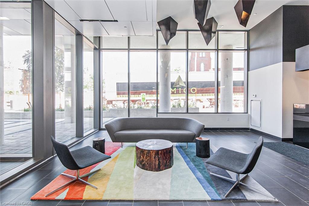 Lobby area featuring floor-to-ceiling windows, dark tile flooring, and a modern ceiling design