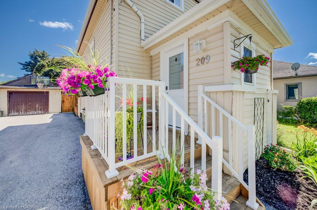 Front entrance featuring light-colored siding and white railings