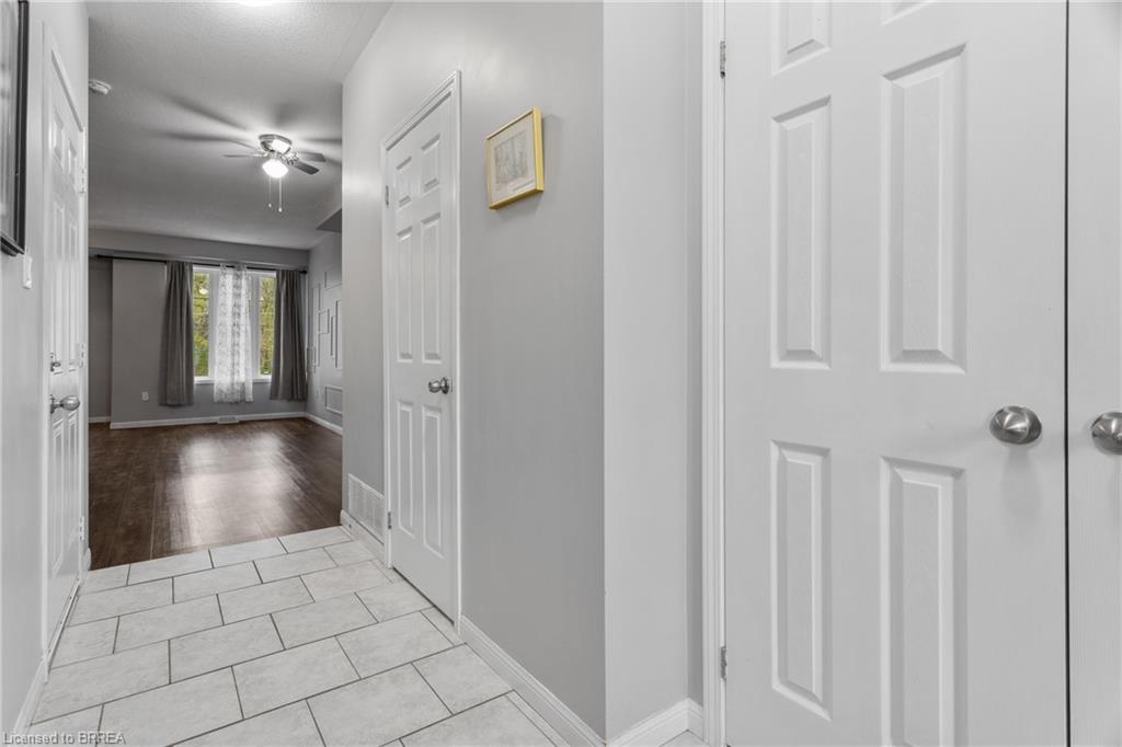 Entryway featuring light-toned tile flooring, white baseboards, and panel doors with brushed nickel hardware