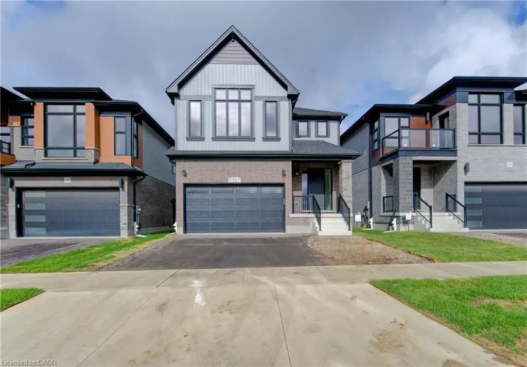 Modern exterior with a contrasting facade, prominent gabled roofline, integrated two-car garage, and a covered entry