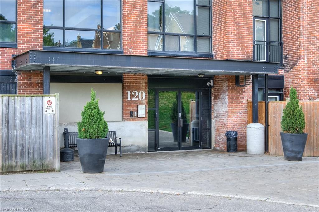 Brick facade entry featuring large windows and a covered main entrance