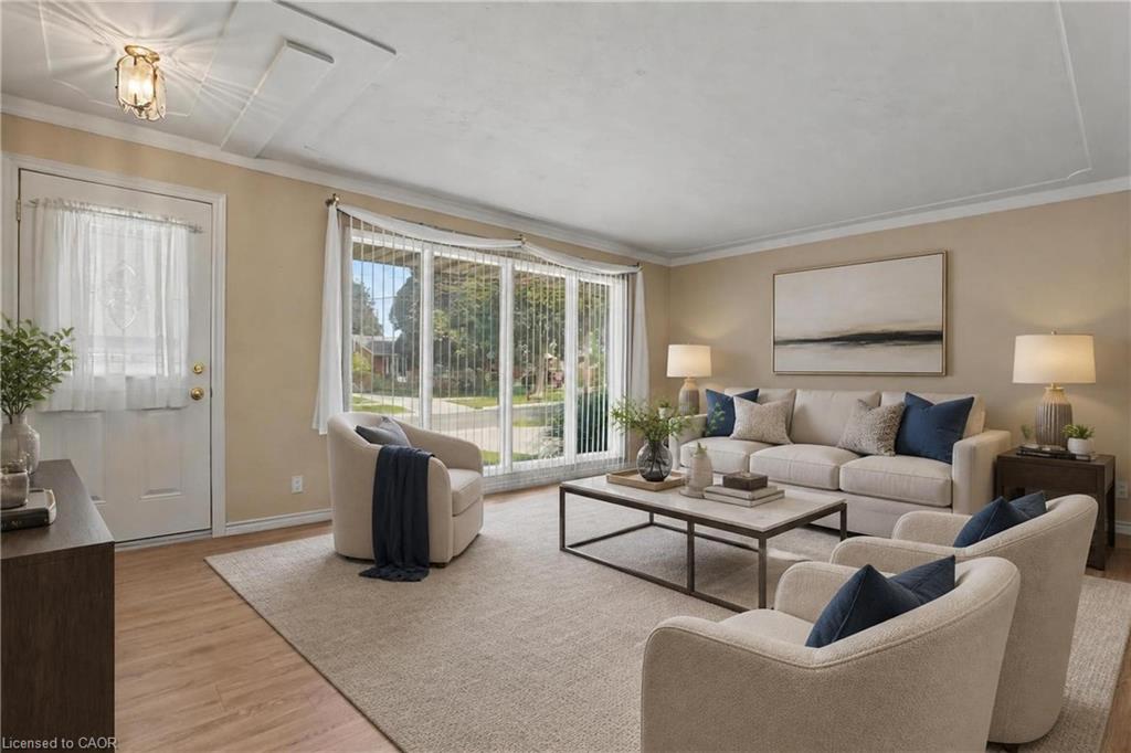 Wood-finish flooring, crown molding, and a decorative ceiling light fixture