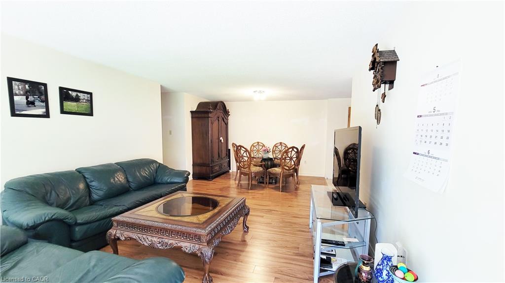 Open concept living and dining area featuring wood-finish flooring
