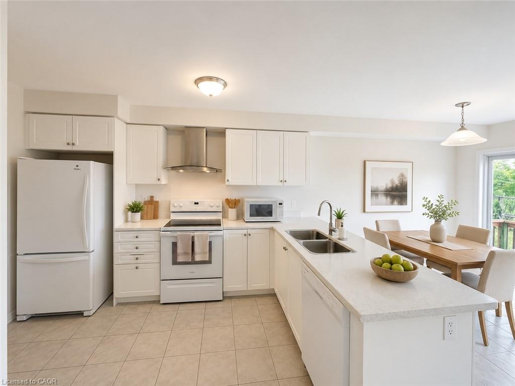 Kitchen featuring white cabinetry, light-toned tile flooring, stainless steel sink, and light-colored countertops