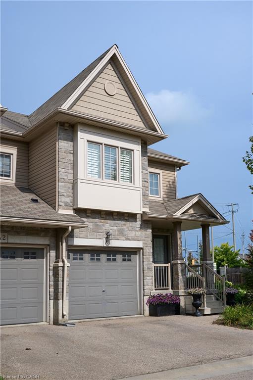 Stone facade with siding accents, gabled roofline, and covered front porch