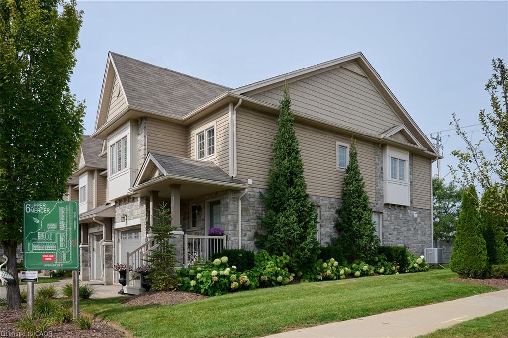 Stone and siding exterior with a covered porch entry