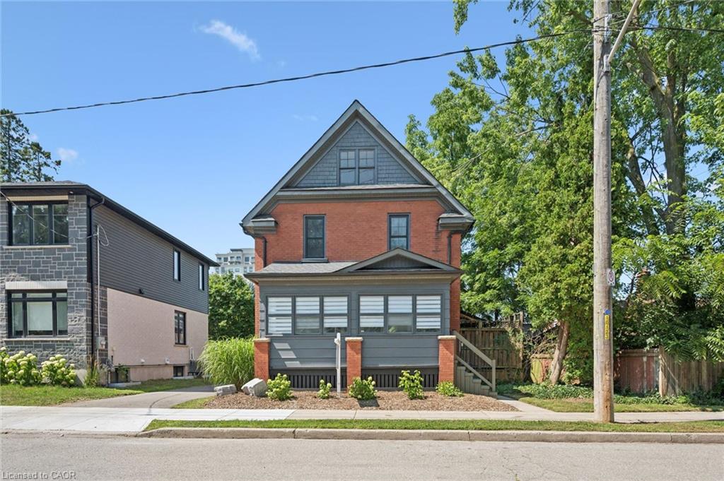 Brick exterior with dark gray trim and shingle accents