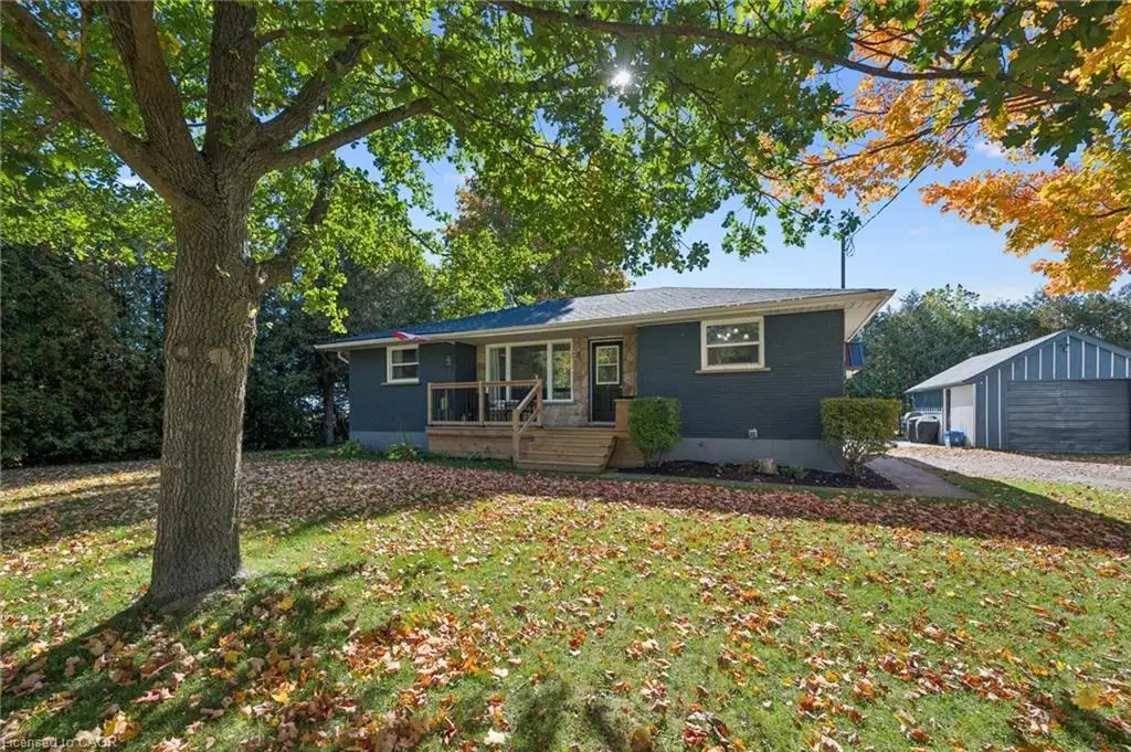 Ranch-style exterior with a wood deck entry and a detached two-car garage