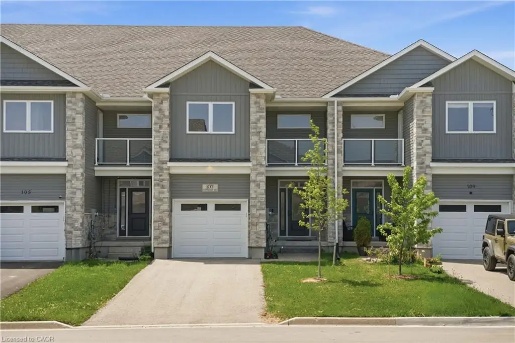 Modern townhome exterior featuring stone veneer accents and vertical siding