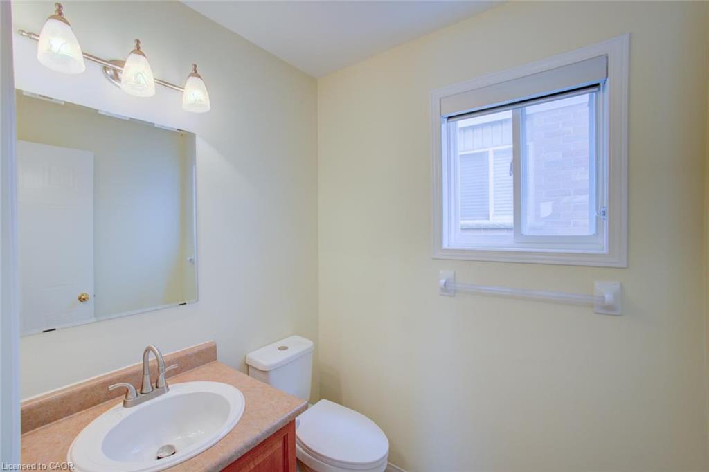 Single-basin vanity with an oval sink, brushed nickel faucet, and a wall-mounted mirror