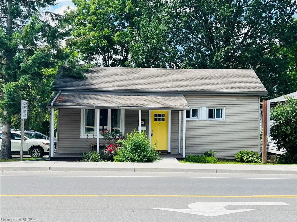 Gable roof with asphalt shingles, vinyl siding, covered front porch, and a vibrant yellow entry door