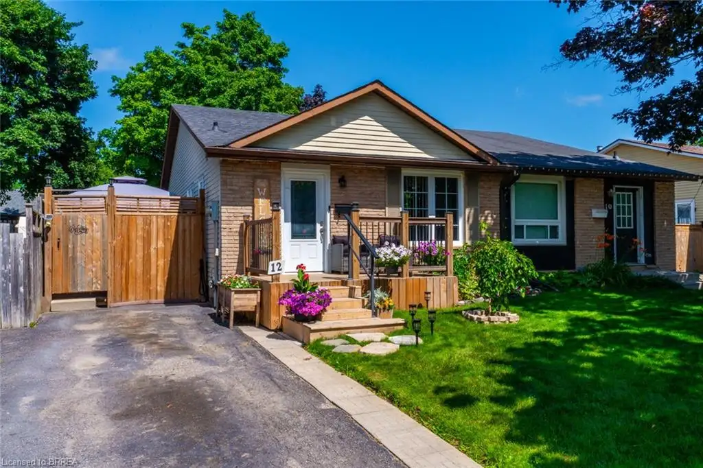 Brick and siding exterior featuring a wooden front porch, a paved driveway, and a fenced side yard