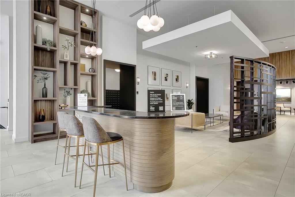 Kitchen featuring a breakfast bar, dark stone countertops, light tile patterned floors, and open shelves