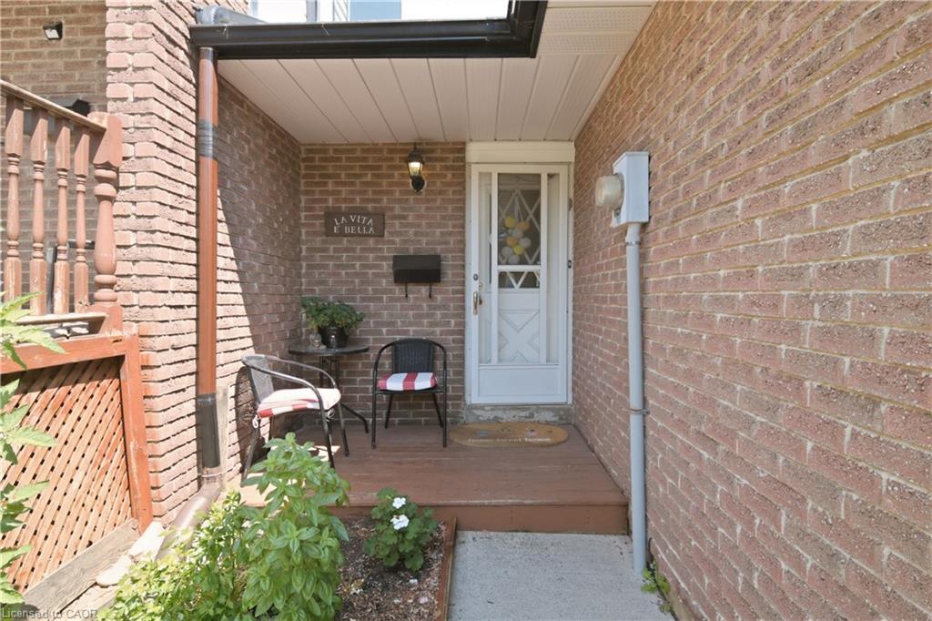 Brick exterior with covered front entry and a wood-finish porch