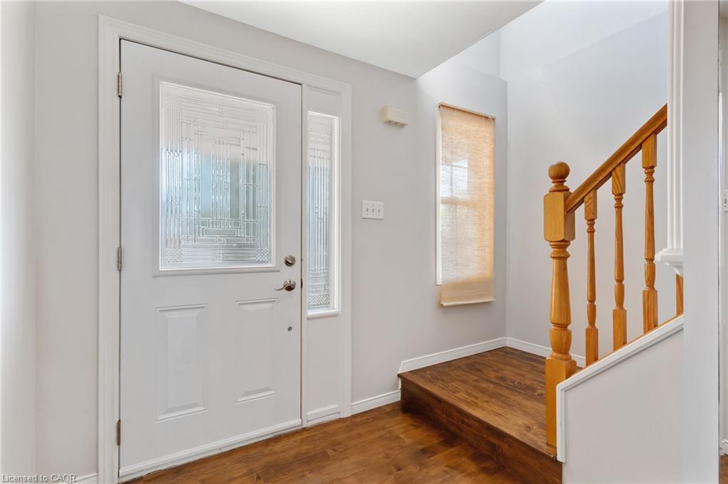 Entryway featuring a white paneled door with decorative glass inserts and a matching sidelight