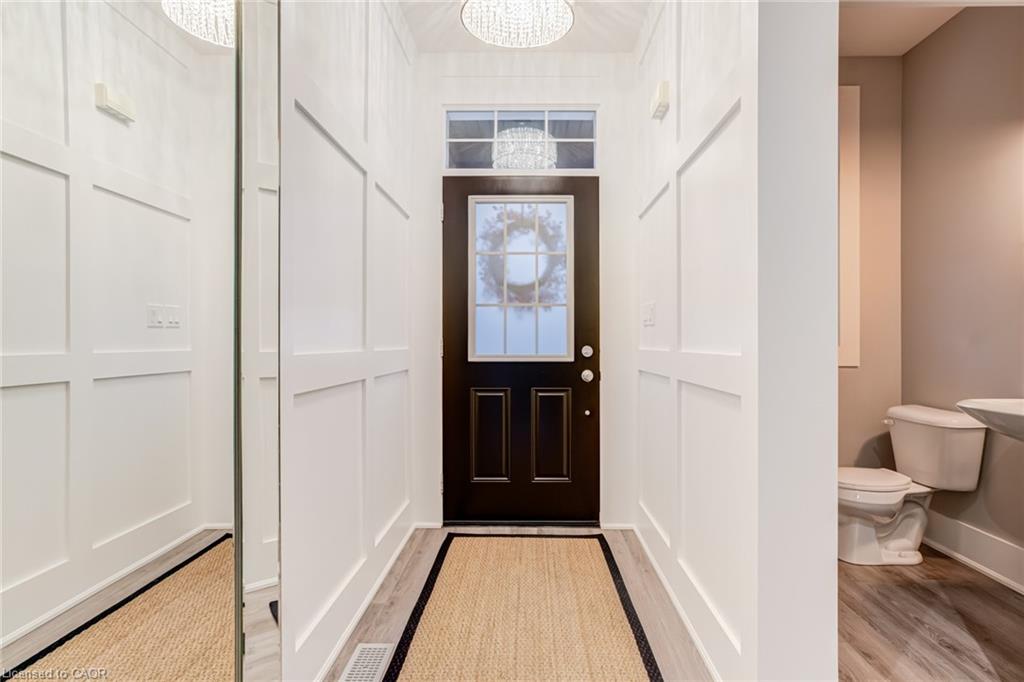 Entryway featuring light wood-style flooring and hanging lights