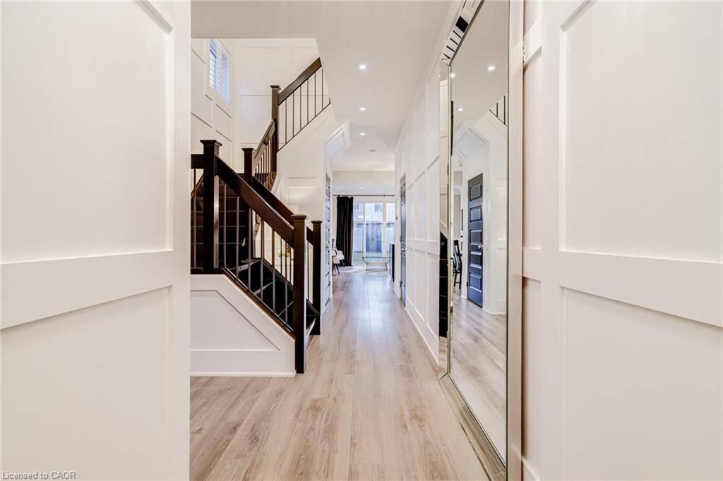 Entryway with light wood-type flooring, recessed lighting, and a high ceiling