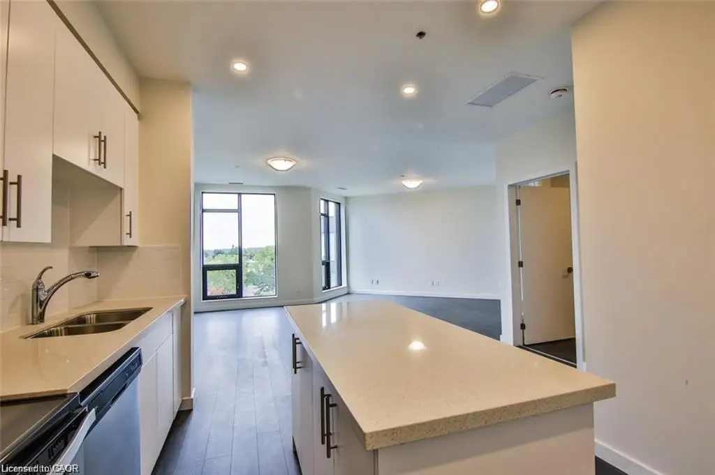 Kitchen featuring white cabinets, stainless steel appliances, a center island, open floor plan, and recessed lighting