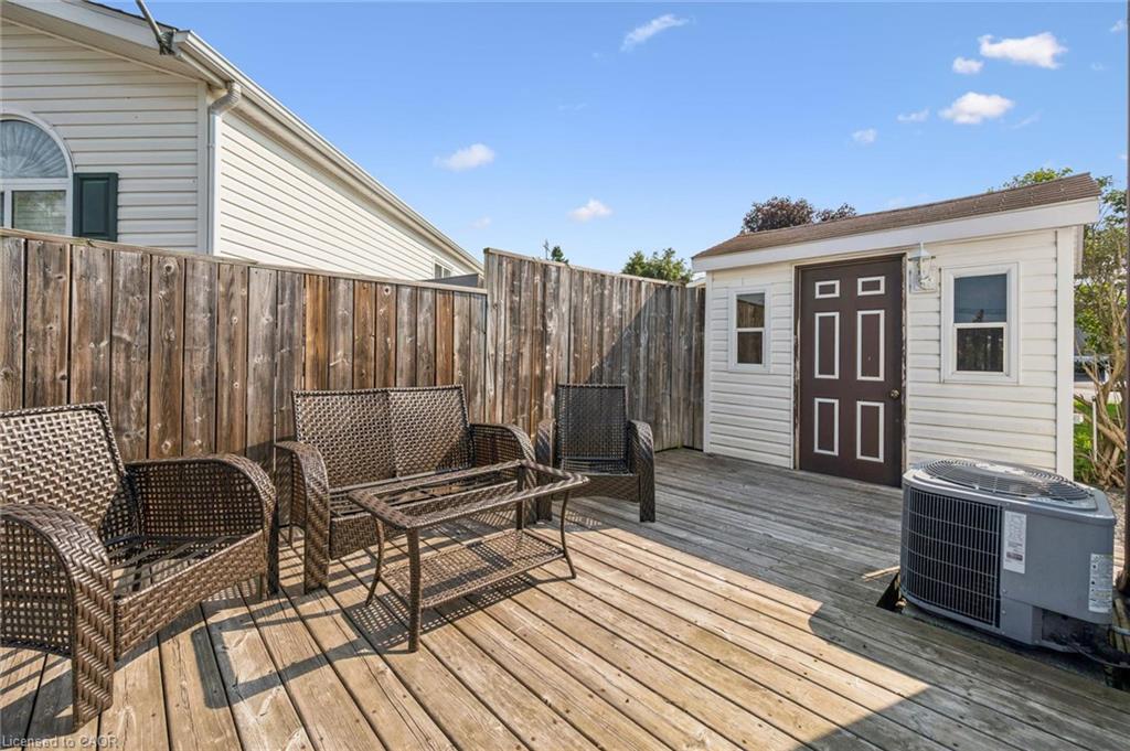Wood deck with a detached storage shed and privacy fencing