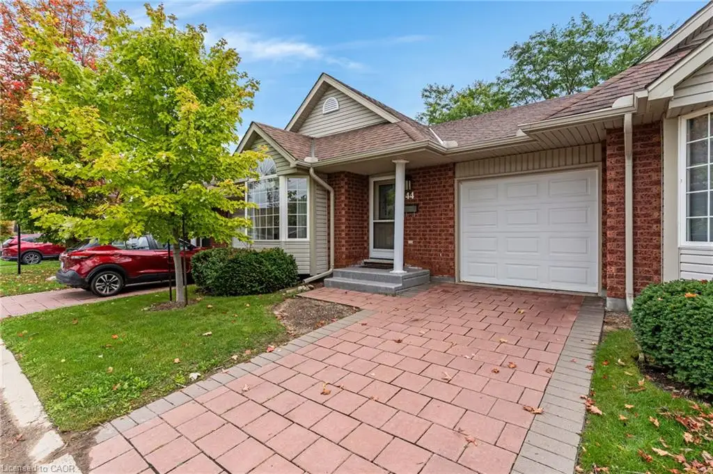 Brick exterior with a peaked roofline, bay window, and an attached single-car garage