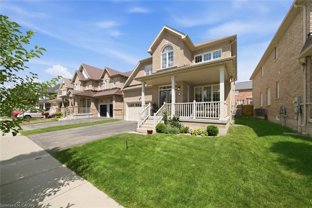 Brick exterior with a covered front porch featuring white railings