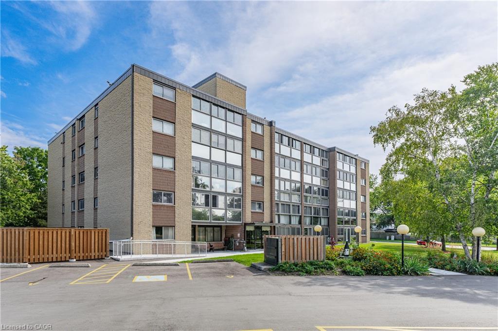 Multi-story building featuring a brick facade with a mix of window styles, including expansive glass panels