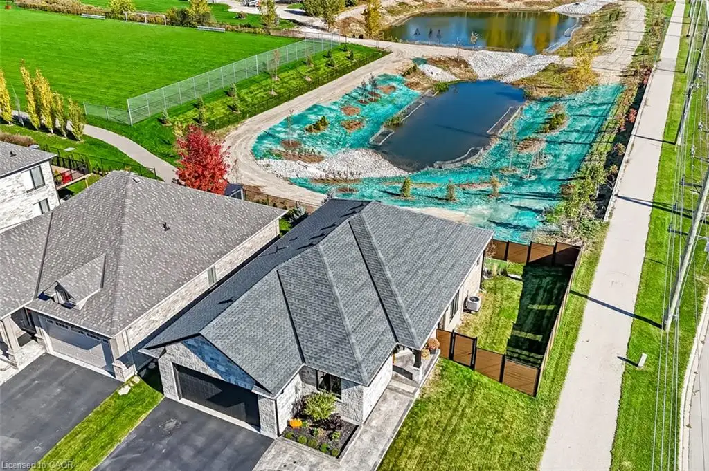 Welcome to 30 Whing Dr., a beautiful bungalow positioned against a backdrop of open green space and water features