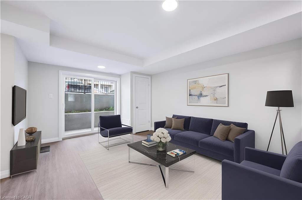Living room featuring wood finished floors, recessed lighting, and a raised ceiling