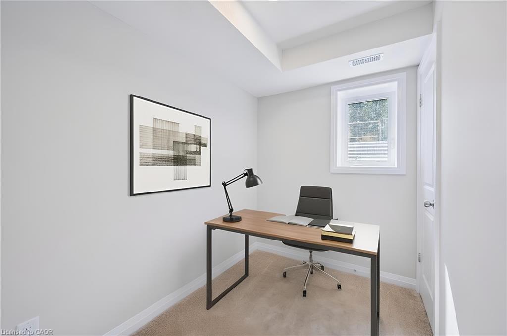 Home office featuring light colored carpet and baseboards