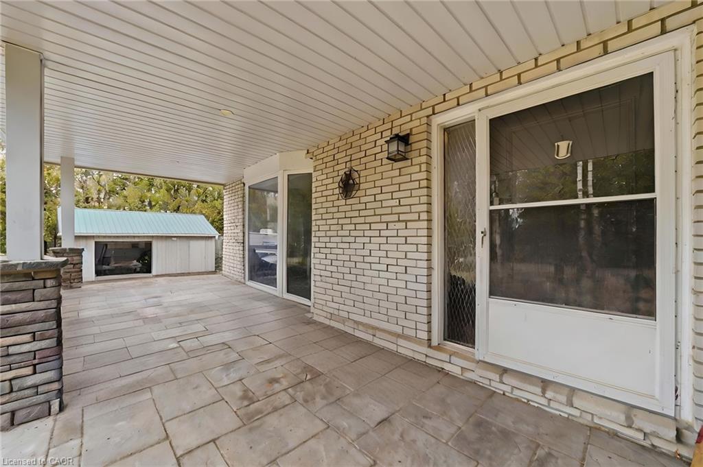 Covered patio featuring stamped concrete flooring and stone-clad pillar