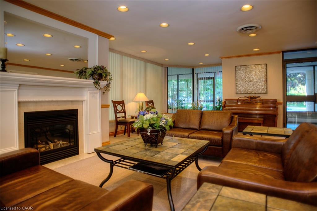 Recessed lighting illuminating a fireplace with a white mantel and a tiled surround