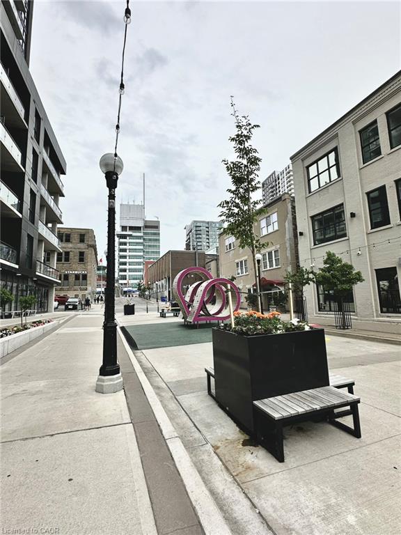 Urban streetscape featuring a decorative lamppost, paved walkways, and architectural elements of surrounding buildings