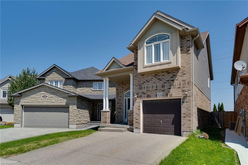 Brick and siding exterior featuring an attached single-car garage and a paved driveway