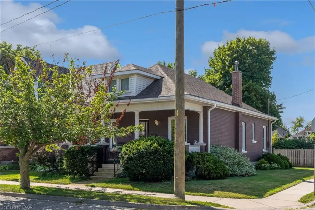 Brick exterior with a covered front porch featuring white columns