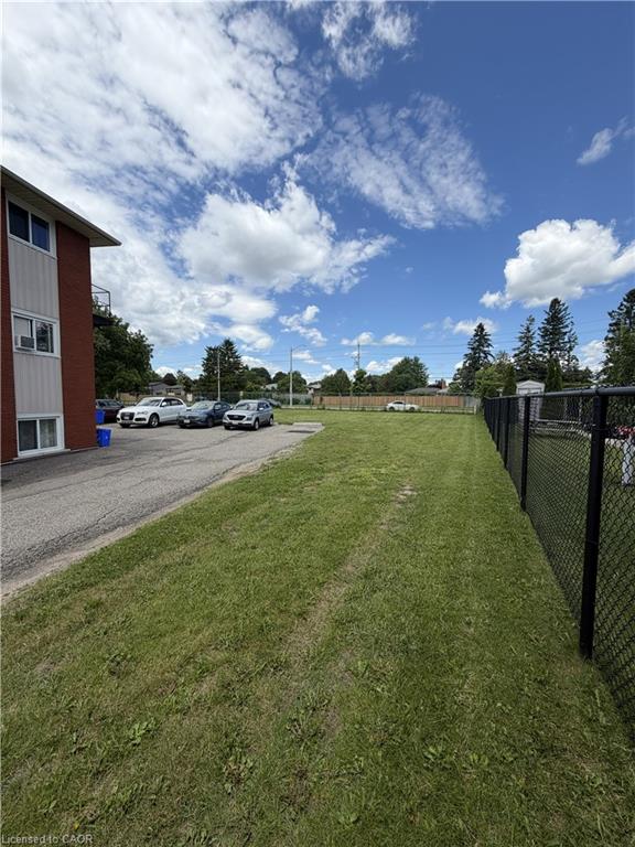 Expansive grass area with a chain-link fence border