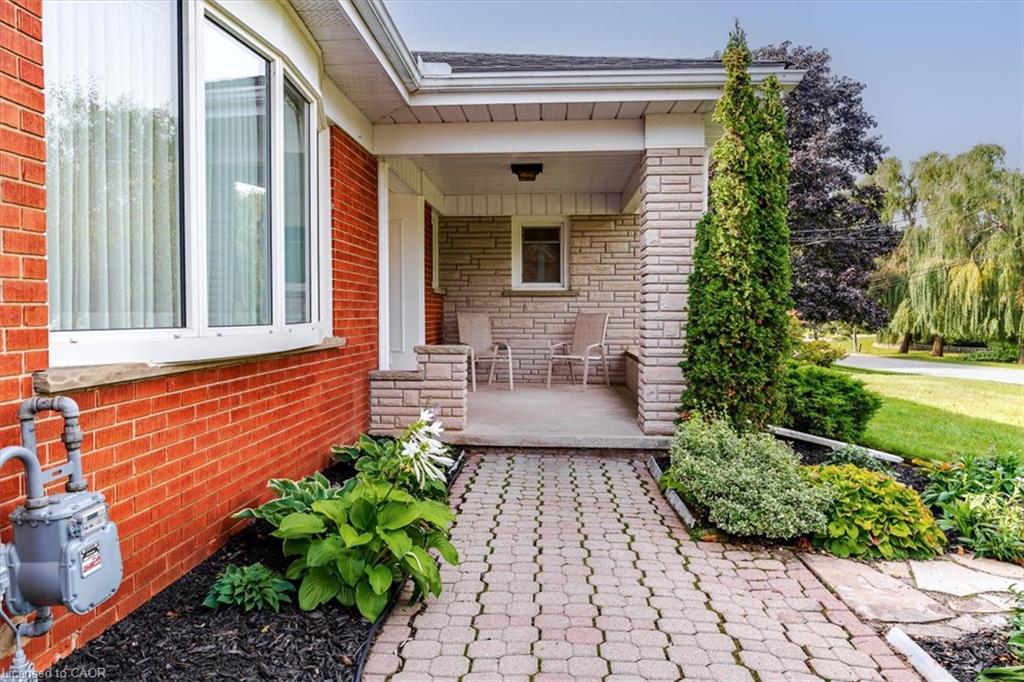 Front entry brings you around to a covered stone-clad front porch, great for enjoying your morning cup of coffee while waiving hello to the friendly neighbours walking by