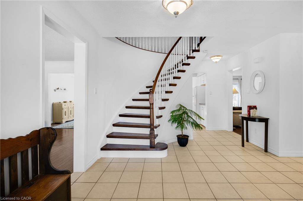 Foyer featuring a curved staircase with dark wood treads and a white spindle railing