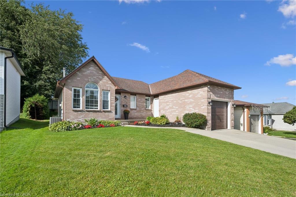 Brick exterior, arched window, attached garage, side-entry garage, mature landscaping