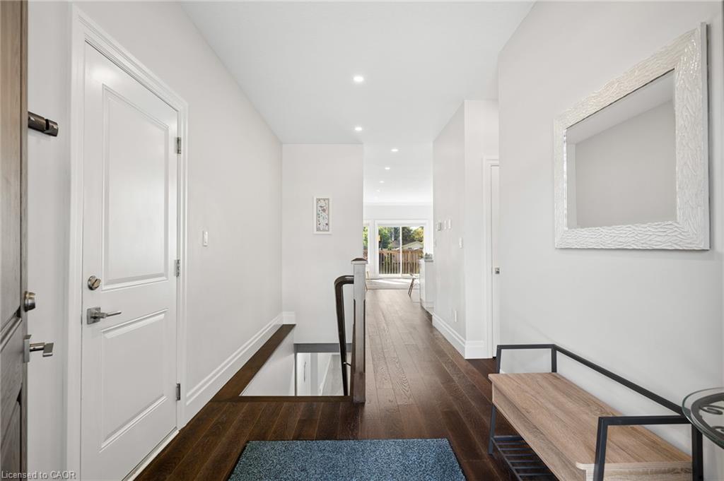 Hardwood flooring throughout, recessed lighting, and white trim