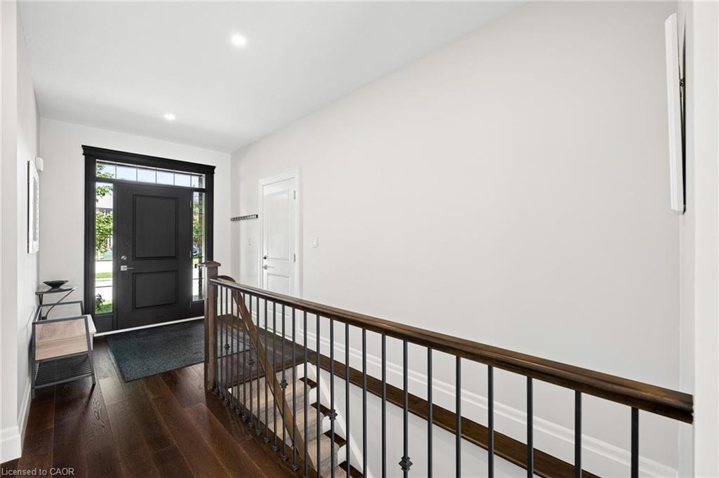 Dark wood-finish flooring Entry door featuring sidelights and a transom