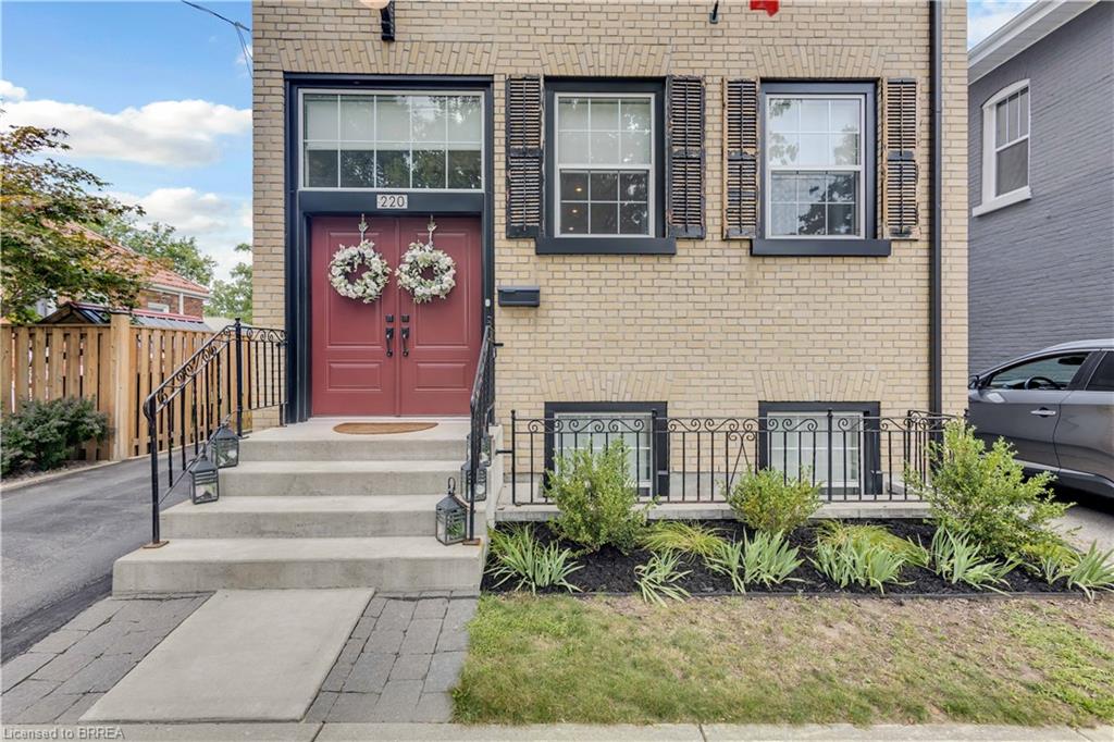 Double doors with transom and large '6 over 6' traditional-style windows.