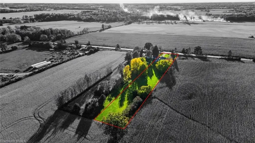 Aerial parcel featuring expansive grounds, mature trees, and defined property boundaries