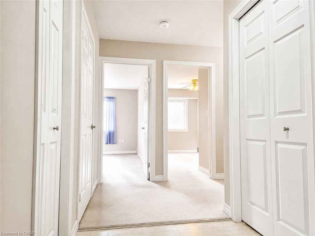 Hallway with neutral wall tones and white trim