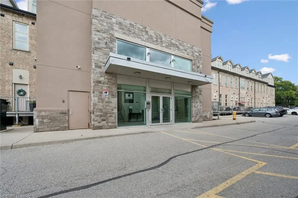 Stone and stucco exterior with a prominent entrance canopy