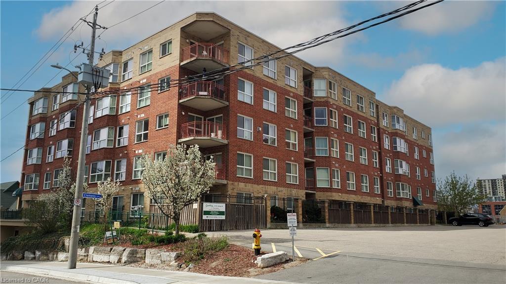 Multi-story residential building featuring red brick and light-colored siding