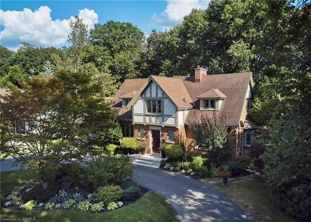 Tudor-style residence with brick and stucco facade, a steeply pitched roof, and dormer windows